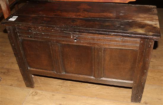 An early 18th century oak coffer, with panelled front, W.91cm